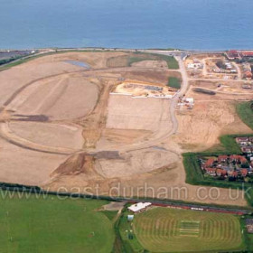 Former site of Vane Tempest Colliery in June 2003. Building just beginning on the new East Shore Village Estate at top right, Dene House Road (Lover's Lane) at right.       Copyright FlyingFotos  www.seahamfromtheair.co.uk