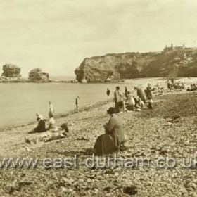 Beach in the late 30's, concrete blocks which supported the railway line still there but rails and sleepers removed. Note pebbled beach.