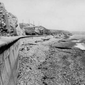 Beach with new promenade c 1960 Northern end of Hall bend just visible top centre. Wooden spiles just visible on beach the groynes of the 50s are seldom visible these days