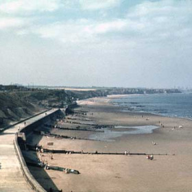 Beach and Sea Wall c 1970 the chimneys of Vane Tempest Colliery centre left, looking N to Sunderland CR The 11 groynes were built in 1955 to stop beach erosion, now seldom visible they were very popular wind breaks as can be seen here