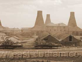 The four bottle houses at the southern end of the site, Gallery Row at right. 1870