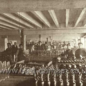 Candlish Bottleworks, bottle packing shop in 1898. Note the electric light bulb, the bottleworks generated their own electricity.