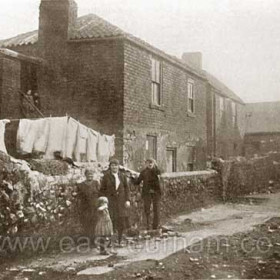 The rear of 16 Back North Railway Street in 1918, Mrs Elizabeth Taylor at left, Paddy Duggan (with wooden leg) right.