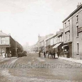 Church St looking west, original United Methodist Free Church at right, built in 1866, rebuilt in 1877 destroyed by fire in 1904.  Originally the upstairs rooms of 2 houses were converted into a church known as the Tabernacle, these houses were demolished in 1866. Wright the butcher opened this shop (next to Vane Arms) at 73 Church St before 1890. The shop at left, the Danish Dairy Co, was trading here with W Allen as manager in 1899.Photograph taken 1899