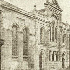 United Methodists originally worshipped in a Tabernacle in upstairs rooms of a house or houses (built early 1840s) which originall occupied this site. This the first chapel, built in 1846 was enlarged in 1866 and again in 1877 to seat 750, it was burnt out in 1904 and was replaced in 1905 by the chapel in the previous photograph.