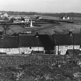 Looking north from the pit heap. Butcher Street in the foreground, Seaham Park behind with WW1 war memorial at centre then bowling green, tennis courts and cricket field to right. Aged miners homes top left. Photograph c 1955.