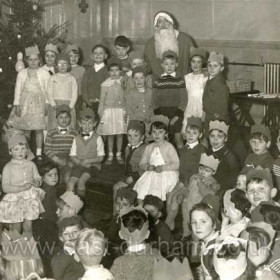 St Hild and St Helens Sunday School Christmas Party,  probably about 1963-64
In the front left area we have Alan Whitwell and Alan McAndrew and behind them Stuart Knowles and Howard Huntley.   On the edge of the stage Joe Kennedy and my brother Douglas Johnson. Standing with Santa we find Stephen Huntley, David Dixon and Alan Dunne. Over on the right are Johnny Green, Arthur Jackson and me Bruce Johnson putting my tongue out. I am sure other people will spot themselves in there - but those are as many as I can be sure of right now.
Photograph and info from Bruce Johnson