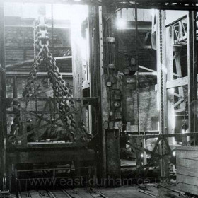 Dawdon Castlereagh Shaft at surface, men in cage at left. Photograph 1959.