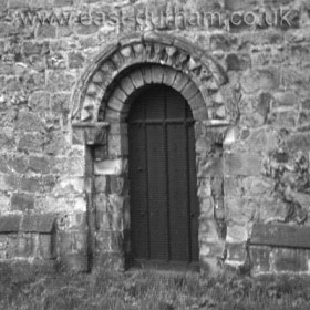 North Door of St Andrew's Church with distinctive round Norman arch and zigzag carving dates from the late 1100s.