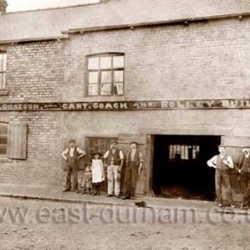 John Dickeson's Burnside Works (carpenters), cart, coach and rolley builder, Dalton le Dale. John Dickeson at right, the three men at left are probably John, William and James, his sons. Photograph probably between 1910 and '20