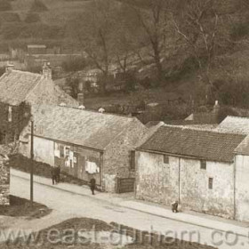 Ivy covered vicarage at left, piggery just visible above, bank to Times Inn at top left.Photograph 1912 or later as Rose Cottage is gone.