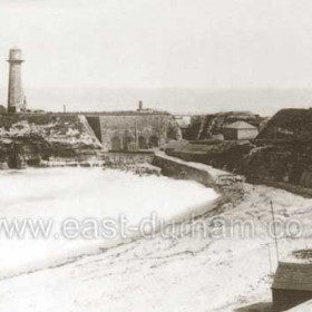 Terrace beach, old lighthouse, original lifeboat house in foreground, built in i854 for the first lifeboat ' Friend of all Nations ' it became a teashop after 1870. Photograph 1890's or earlier