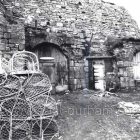 Old lime kilns used as storerooms at the time of this photograph, 1981.
Photograph by Harry Skinner