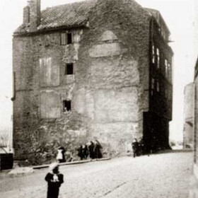 In the far distance (right)  it can be seen that the end of Low St formed the original fish quays but there were properties between the river and Low street for most of it's length.  In the the early 1900s the demands for larger quays resulted in these properties being removed. This building, already isolated, is ready for demolition and the child stands on ground soon to become The Deep Water Quay.
     Photograph Norman Kirtlan, caption Len Charlton.