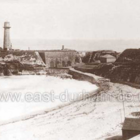 Seaham's first lifeboat was provided by Lord Londonderry in 1854/55, possibly earlier, no records of this boat survive.
The "Friend Of All Nations", Seaham's second boat was bought by  public subscription some time after 1855, built by a Mr Hawkesworth of Torquay she was self-righting and probably 40 feet long. Kept in a boathouse at the southern end of the Terrace Beach she proved difficult to launch across the beach and by 1870 was replaced by the "Sisters Carter of Harrogate" in 1870.
The photograph shows the boathouse in the right foreground, in the 1870s it became a tea shop and was demolished in 1899.