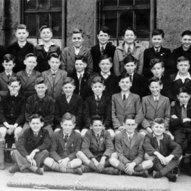 Seaham Intermediate School,  Class 1A. 1945/46.

Order  as per photograph from Left to Right.

               Name.               Address/Area.

1. ‘Cush’ Currie. Teacher.  Princess Road.

2. Bruce Davison.

3. Brian Whitten (Witton). Adolphus St. West.

4. Matt Finkle (?)  Deneside.

5. Harrison  Mullen.

6. John Hall.

7. George  Purvis.

8. George Meek. Londonderry Yard.

9. Arthur Williams.  6 West Street.

10.Raymond Bell.  Deneside.

11.Warren Williams.  1 Henry Street.

12.John Scrafton.

13  ?   Pickering.

14.John Cockerill. Seaton Lane.

15. (Harrison ?)

16.William Lawes. (Larky)  Parkside.

17. John Cooper. Park Avenue.

18.Corbett Ross.  Off St. Aldwyn’s Rd.

19.David Conn.  Seaton area.?

20.Joe Nelthorpe.

21.Brian  Heads.  Deneside.

22.Ronald Burns. Earl St.

23.      ?

24.      ?

25.      ?

26.Norman Knapp. 27 North Railway St.

27. Derek Slee.

28. Malcolm Murray.

29.William Black. North Terrace.

30. Wilf Redshaw (?)  Deneside.

31.Fred Alan.   Deneside.

32.George Dyer. Deneside.

33.Derek Strong.

34.Robson Henderson.

35.George Jones.

I'm shown at No 26. I wonder how many of those portrayed are still alive and kicking. I have been in touch in the last two years with No's 8,9,11and18 but would be interested to hear of any others.

I left Seaham in 1958 and now reside in North Yorkshire; however, I do visit Seaham.

Norman Knapp.