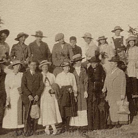 Group of Seaham people photographed after returning from a picnic in Hawthorn c1915.
Back Row, L to R;
Miss Kirk, Miss V Scott, Ethel, Miss H Scott, Roy Bainbridge, Miss Henderson, Gladys Samuels, Hilda Muriel.
Front Row;
Mr Bainbridge, Minnie, Pathe, Miss Cook, Bessie, Miss Bainbridge, Mrs Banks, Mother (of WF Smith?) Private Abbey DLI.