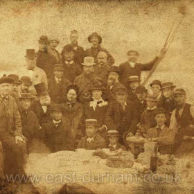 What looks like a picnic on a sailing ship, a very old photograph from a glass negative.