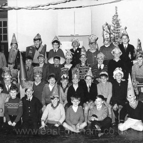 This is around Xmas 1965, in the hall of the Dawdon Junior Boys School.  These young gentlemen were from the two top classes,   Mr Stockdale's  and  Mr Hall's. 
Back row includes,  me - Bruce Johnson in my magnificent national health glasses !   and also Alan Davidson,  Alan Marlborough,  Richard Jane, Joseph Kennedy, Mystery Guest,  John Parish
Next Row includes   Howard Huntley, Stewart Knowles, Alan McAndrew, Norman Parrington,  Johnny Green, David Swan, Joe Gibson
Third row includes  Derek Henry,   Michael Anderson, Edward Donaldson, David Dobbinson, John Reed,   Malcom Redden,  and the man in the pointy hat could be Kenneth Burrel 
Front Row  includes  Robert Hogwood,  David Lowry, Colin Moore,  Wilfred Sheppard,
Photograph and caption from Bruce Johnson, Bruce mentions in his Email that he has been working in London for over 30 years but still remembers his old school friends.