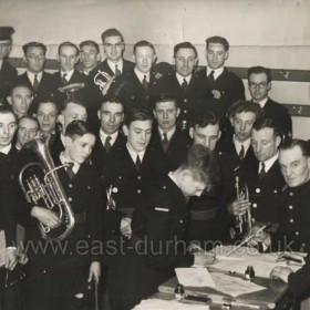 5th Seaham Scouts.They met at the Mission Hall next to Eastlea School
The band reformed after the war as the 5th Seaham Silver Band
A new recruit signing on for the band, I am not sure if it is Billy Ferguson
whose brother Matthew is just behind him or Charlie Butler whose dad later became Conducter.
Matthew and Billy Ferguson both qualified for the Military College of music
and both had careers as military musicians.
Photograph and info from Marian Johnson