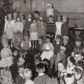 St Hild and St Helens Sunday School Christmas Party,  probably about 1963-64

In the front left area we have Alan Whitwell and Alan McAndrew and behind them Stuart Knowles and Howard Huntley.   On the edge of the stage Joe Kennedy and my brother Douglas Johnson, Standing with Santa we find Stephen Huntley, David Dixon and Alan Dunne. Over on the right are Johnny Green, Arthur Jackson and me Bruce Johnson putting my tounge out. I am sure other people will spot themselves in there - but those are as many as I can be sure of right now.
Bruce Johnson