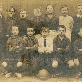 Bottleworks School
the boy at centre of back row is my maternal grandfather James Robson Cummings. He was born in 1899 and lived in Pilot Terrace and  Gallery Row during his school days. He attended Seaham Harbour Council School and I believe this a school football photograph. 
He served in WWI, worked at Seaham Docks as a trimmer and died in 1981.
B Slee