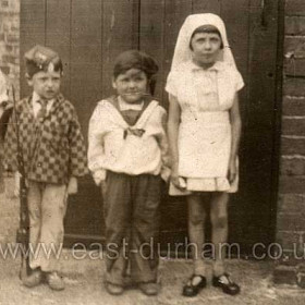 Alan Tait, in a sailorv outfit with his friends in a back yard at Frederick Street.
On the evening of 15th February 1941 a Heinkel 111 bomber heading north dropped bombs on Seaham, demolishing the subway at Lord St and nos. 7 - 11 Frederick St.
Alan was unhurt and passed through a window to the street by his mother. His friend in the soldier outfit was killed, the only fatality of the raid.
The bomber was apparently hit by anti-aircraft fire as it continued north and after hitting a barrage balloon cable, crashed at South Shields killing the five man crew. 
Photograph from Derek Tait