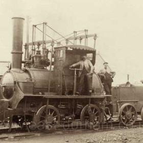 Hetton Loco 1900. This is reputed to be one of the original three steam locomotives built by George Stephenson for the Hetton Colliery Railway in 1822 (see previous caption).  The locomotives were origially named "Dart", "Tallyho" and "Star".  The wooden cabin in which the engine driver is standing was added at some time in the locomotive's history.  The engine was exhibited at the Centenary Celebrations for the Stockton & Darlington Railway in 1925 and was subsequently housed in the original Railway Museum at Queen Street, York.  It is currently (August 2008) being restored for display at either the North of England Museum at Beamish or at Shildon Museum. 
Photograph pre 1914 
Caption by Sheldon Clark
