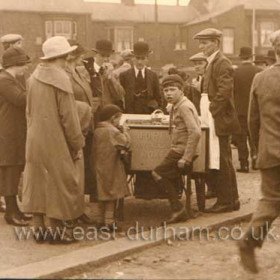 Here's a scene from the days when you could buy all sorts of things in your own back lane. This is my dad's cousin, Jack Reay, selling home made ice cream from a barrow at the back of Roker Avenue on August Bank Holiday Monday in 1925. Don't you just love the fashions?        
Photograph and caption from Malcolm Fraser