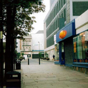 A photograph taken in 2002. Who would recognise this as the Union Street featured in the previous photograph?
The name 'Lockharts' can still be seen above the shop at the top of the street. The main building on the right is Littlewoods store which replaced the North end of the railway station.