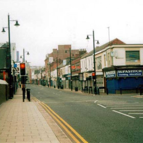 A 2002 photograph of Holmeside. The main difference that has occurred in almost 100 years is the absence of the tramlines and of course all the shop- ■ fronts are shuttered, which unfortuneately reflects the present day atmosphere of constant break-ins and burglaries.