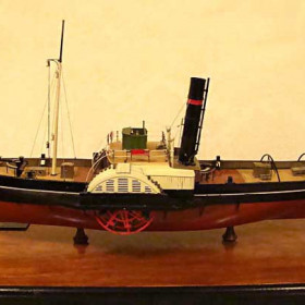 MODEL OF "RELIANT", THE LAST STEAM PADDLE TUG.
Built by Bassett Lowke model maker Lawrence George Ward.        
This is a museum quality model in perfect condition..
This model is on sale on eBay by pnc-shop, item No 380086286994                       

The Reliant was previously called ‘Old Trafford’ and was built in 1907 by Joseph Eltringham of South Shields for the Manchester Ship Canal Co. 

It was fitted with two surface-condensing, side-lever engines, which were built by Hepple & Sons of South Shields. The two engines could be run separately or together and for extreme manoeuvrability, one could be run forward and the other in reverse, which could make the tug turn on its own axis .It was also capable of equal pull both forward and reverse. 
Steam was produced by two coal-fired boilers. 

The paddle wheels were fitted with 'feathering floats' (ie paddle blades), which allowed the angle of the floats to alter so that they entered and left the water in a vertical postion. This made them more powerful than the 'fixed float' paddle wheels, which had to force themselves into and out of the water at an angle. 

In 1951 it was sold to France Fenwich Tyne and Wear Co. and renamed the ‘Reliant’ and worked on the river Tyne for the next 5 years. 
In 1956 it was sold to the Seaham Docks & Harbour Co., in County Durham, where it worked until 1969, guiding ships into the narrow harbour entrance. ‘Reliant’ was taken out of service in that year and was towed to Charlton, on the river Thames. 
The vessel was dismantled and then re-erected, by Cory Bargeworks Ltd, in the Neptune Hall at the National Maritime Museum, Greenwich. In 1996 it was again dismantled and removed from the N.M.M. to make way for some new displays. 
The starboard engine has been refurbished and put back on display in the N.M.M. It is driven by a 40hp electric motor through a 60:1 gear unit. 
The port engine is under restoration at Markham Grange Steam Museum.
Reliant was scrapped in 2002.                                                                  

Tug Details: 
Displacement of 100 tons 
Length of 100ft (31 metres) 
Width over paddles of 36.5ft (11 metres) 
Beam of 20ft (6 metres) 
Draught of 7ft (2.25 metres)