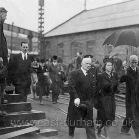 Princess Elizabeth visits Sd shipyard.
Surtees Gleghorn a16 year old apprentice plater at front left
The shipyard was Sir James Laing at Sunderland and the oil tanker being launched was built for the Anglo Iranian Oil Company Ltd later to become British Petroleum. The ship was called British Princess and Princess Elizabeth (later The Queen) officiated at the launch which was on 30th April 1946. The photo appeared the day after in The Daily Express. The caption read "Shipyard curtsy in the rain. The knight offers the Princess his umbrella and the workman doffs his cap."         Photograph and info, Marion Atkinson