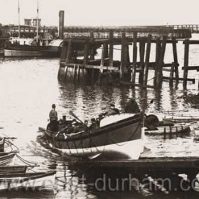 This looks very much like the South Outlet at Sunderland, if you were to walk down and through the bridge on the Hendon road it was in that vicinity, They had four different stations at Sunderland all on the Hendon side the new Stations are on the other side one in the Marina and one on the Sea Front. 
The Lifeboat on the slipway, was named Richard and Nellie Hodgers, on number 368
Placed on Station in 1894 to 98 she was a 38 ft pulling  lifeboat.
Information from Bob Williams
Photograph from Malcolm Fraser