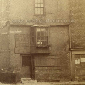 Detail from previous photograph.
Street signs read... Sandgate to left and Milk Market to right.