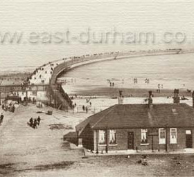 Roker Pier
This photo show the new north pier and lighthouse which was opened in 1903. This with a new south pier enclosed the old harbour entrance which had small original piers dating back to 1786. The old north pier had its own lighthouse and more than one ship tried to enter the harbour between the two lighhouses and ran aground on the beach.  The old lighthouse is now a plain navigation aid. The new north pier is no longer open to the public. 
 
The house in the foreground is the lighthouse keeper's cottage built on the blockyard which was formed to store the blocks used to construct the pier. A rail line was built on the pier as it was extended to carry the blocks. It can be made out on the photo along the right side of the pier.   
Information from Len Charlton.