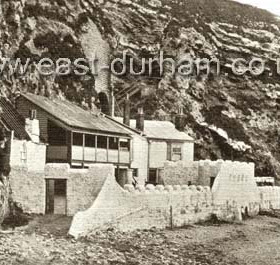 Marsden Grotto, pub and restaurant on the beach a little north of Seaburn.
The history of the Grotto goes back to the 1780s when a miner  "Jack the Blaster"  cut stairs in the rock face and turned one of the caves into a make-shift house from which he sold refreshments to curious visitors. Later a publican Peter Allen extended the caves and access and after a legal struggle obtained a license acquired by Vaux in 1898. On this photo the railings of the tortuous steps down the cliff face can be seen behind the chimneys.
The development to the present premises with an electric lift was not started until the 1940s.
Information from Len Charlton.