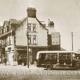 This August 1934 view shows one of the Corporation's two new 'Tram-O-Car' buses outside Alex Hasting's shop at Seaburn. The shop sold sweets and buckets and spades and was also Seaburn post office. 
The little bus is waiting to set off on a sea-front tour to Whitburn, as advertised on the big board above it.  The edge of the tram turning loop is on the left and the Seaburn Hotel was built on the right two years later.       Caption from Malcolm Fraser.