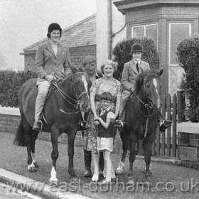 Bill Humphrey and his wife, son and daughters Carol and Sarah on horseback outside Manor House Farm in 1959.