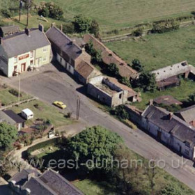 Seaton Village; the Dunn Cow at the top of the photograph; Seaton Hall at bottom left opposite the 400 year old farm cottages which unbelievably have recently been allowed to be demolished to make way for a housing development. Red roofed bungalow at left on the site of the former Blacken Pot Square. Photograph c 1980