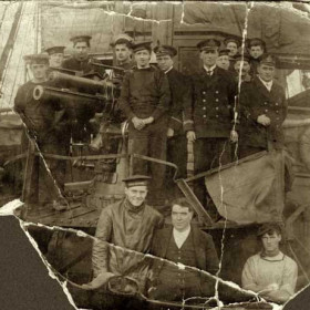 Can anyone help identify this WW1 tug?
"This is a picture of my grandad taken during the 1st W.W. on his tug. My grandad was the skipper of the armed tug ,that's him in the collar and tie, ( very smart ).My dad Duncan Gordon Taylor took me aboard the tugs on the Tyne from a very early age and I can remember having to go with him and travel to Seaham Harbour to join his tug. Anyway the photo is of my grandad Duncan Gordon Taylor sr.and I was wondering if it can be identified by anyone"
Caption and photograph from Duncan E Taylor.