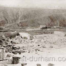 Raised railway on Terrace Beach used to transport sand during dock extensions 1899-1905. New North Pier in left foreground.