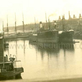 Looking south across the South Dock to Chemical Beach. Tug Seaham at left foreground, Bottleworks on skyline at right, Dawdon Colliery just visible at centre. Photograph between 1908 and 1912.