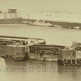 Old South Dock gates date not known, original print hand dated 1870, the group on the pier head and the ladder to the left of the gates suggest that there is a diver under water sorting some problem or other.