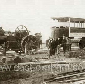 It’s the Spring of 1905 and the men of the Sunderland District Electric Tramways are preparing for the opening of the system. They will have a fleet of 30 trams to start with, half of them English and the rest French. Number 23 is one of the French ones and has just been towed by the traction engine from the docks at Sunderland to the Car Sheds at Philadelphia, north of Houghton-le-Spring. The driver of the engine was fined at the police court in Sunderland for emitting noxious smoke and fumes from his engine. With 15 trams to deliver, it is to be hoped that they didn’t catch him every time!     
Caption from Malcolm Fraser