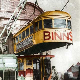 This is the end of Sunderland tram number 26, being dismantled in the yard of Hylton Road depot at the top of Silksworth Row in the spring of 1953. It was one of a set of three modern trams built inside this depot in 1935. The advert on the side is for Palmers store, which used to be in Saint Thomas Street, and mentions both radio and television. The local TV transmitter had opened just a year earlier, in time for the coronation, and there weren't many tellies about, so RADIO is in bigger letters.
Hand coloured photograph and caption, Malcolm Fraser