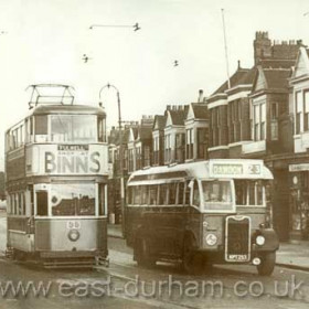 It is a dull day in Ryhope Road at Grangetown in August 1952 and tram 36 has just left the terminus at Ocean Road on its run to Fulwell. It is about to make its first stop and the people on the left are ready to meet it in the middle of the road. Northern General bus 1253, a 1949 Guy, is heading the other way for Ryhope and Dawdon. Marshall the Chemist has a large board above the shop showing that they dispense NHS prescriptions, introduced only four years ago. In the background, tram 81 is coming towards us to reverse at the terminus. There is a tram every three or four minutes - but not for much longer, because this tram route will close on Sunday 30th November.    Caption from Malcolm Fraser