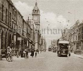 Fawcett Street 1910?  In the 1880s Fawcett St still consisted of expensive terraced housing and institutes but it quickly developed into the the commercial centre of Sunderland. Less than half a mile long with the Town Hall in the centre it ran from the southern end (photo foreground) to Mackies corner where it crossed High St West and became Bridge St.  The railway lines and central station ran parallel to and behind the properties on the west (photo left) side.  By the 1900s it was a very busy street with libraries, clubs, banks restaurants and quality shops. Many premises had their own commissionaire welcoming their more affluent customers by name. 
Information from Len Charlton.