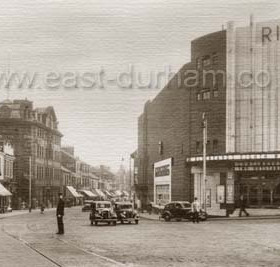 Holmeside, after 1937.  Vine Place is behind the camera, Crowtree Road to the left and Park Lane to the right  while Holmeside runs ahead towards the town centre. The Ritz cinema opened in1937 but became the ABC in 1961 and the cars seem right for the earlier date.
Information from Len Charlton.