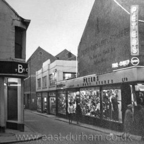 View down Middle St from Crowtree Rd. Peter's Army and Navy Stores at right. Middle St ran parallel to High St West from Union St up to Crowtree Rd where this photo was taken. also see SDTC 048 
Photo N Kirtlan, info Len Charlton.